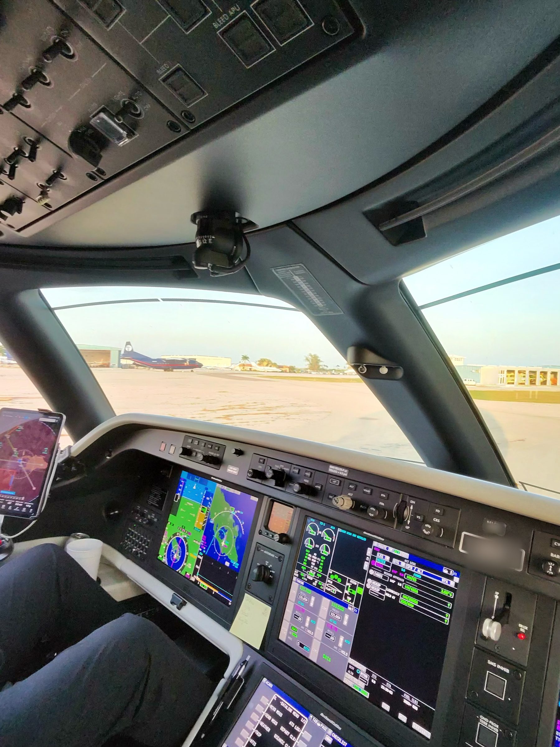 Business jet flight deck on the ramp with avionics displays powered on